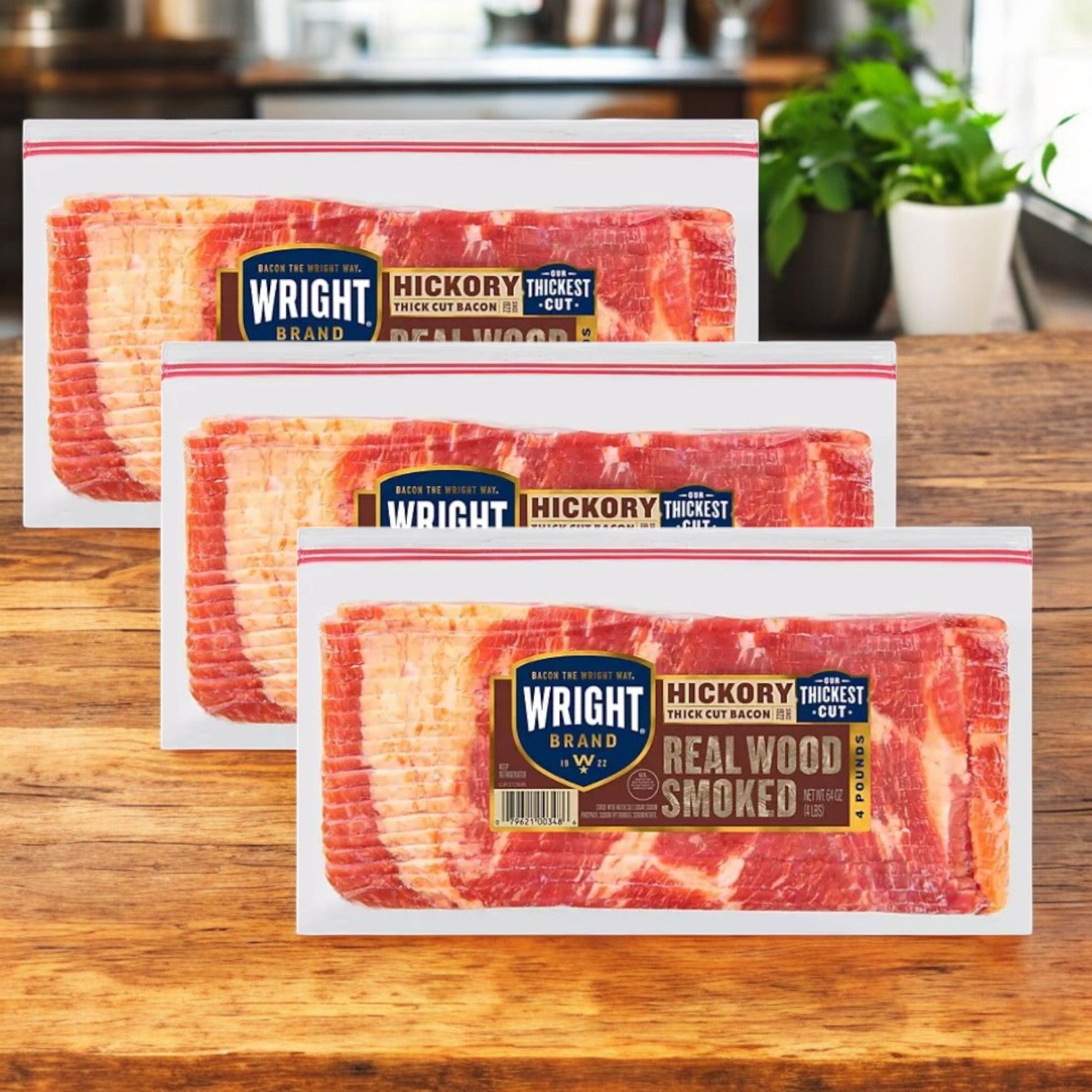 Three packs of Wright Brand Thick Sliced Hickory Smoked Bacon, 4 lbs, 3 Count, are arranged on a wooden counter with a plant elegantly in the background.