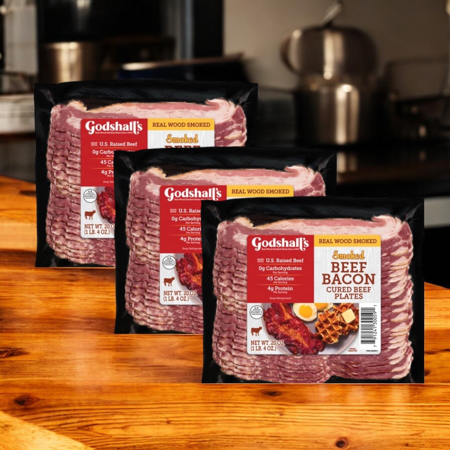 Three packs of Easy Lunches Godshall's Beef Bacon 20 oz. 3 count are displayed on a wooden countertop in a kitchen.