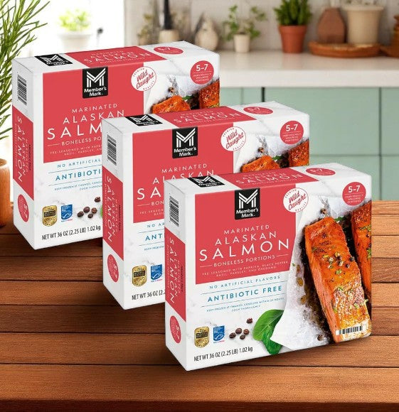 Three cases of Member's Mark Wild Caught Boneless Marinated Alaskan Salmon (2.25 lbs. each) sit on a kitchen counter, featuring antibiotic-free, no artificial flavors, and premium frozen wild-caught salmon.
