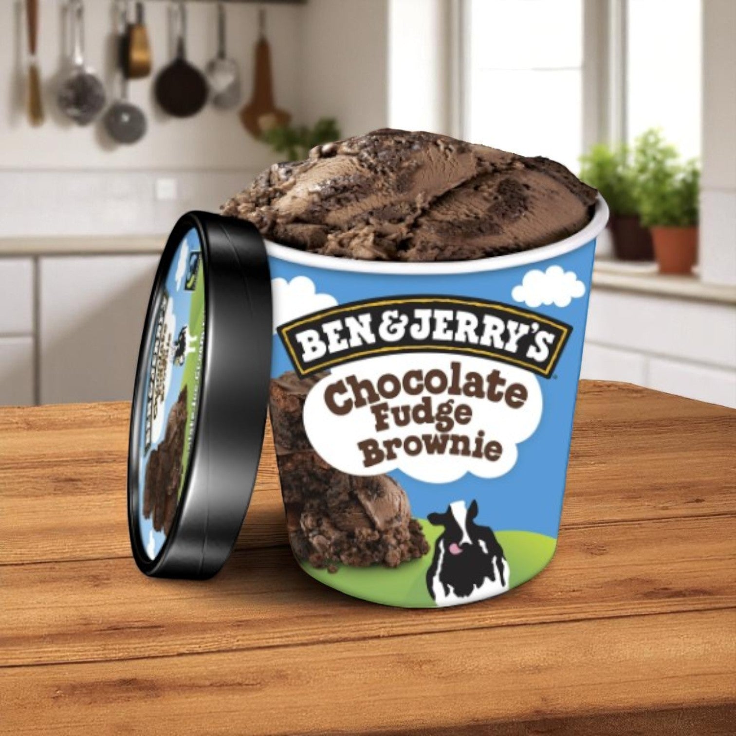 A pint of Easy Lunches Ben & Jerry's Chocolate Fudge Brownie Ice Cream (16 FL Oz) sits on a kitchen counter, lid off, tempting you with rich chocolate ice cream and fudgy brownie chunks.