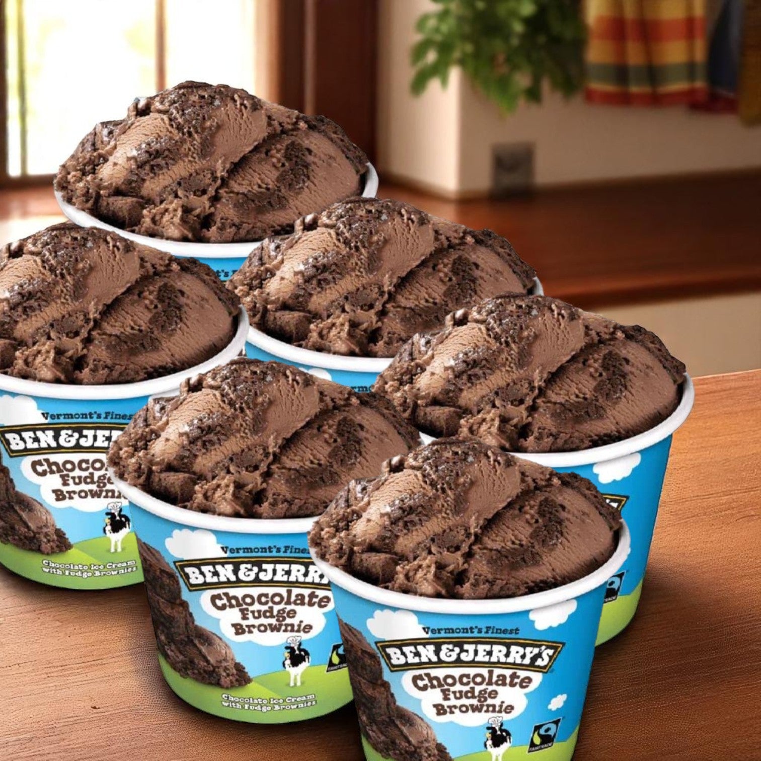 Six pints of Easy Lunches Ben & Jerry's Chocolate Fudge Brownie Ice Cream (16 fl oz each) are arranged on a wooden surface, offering a decadent treat packed with rich chocolate and fudgy brownies.
