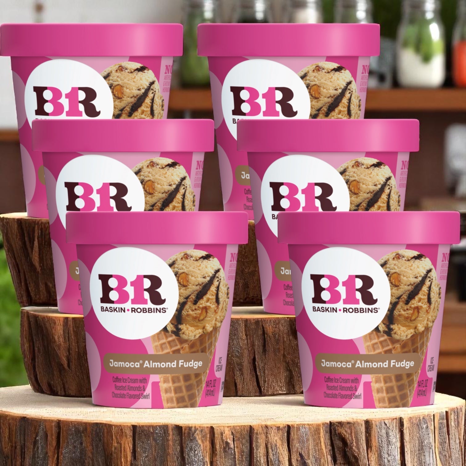 Six containers of Easy Lunches Baskin Robbins Ice Cream Jamoca Almond Fudge (14 oz each) are stacked on wooden surfaces in a cozy kitchen.