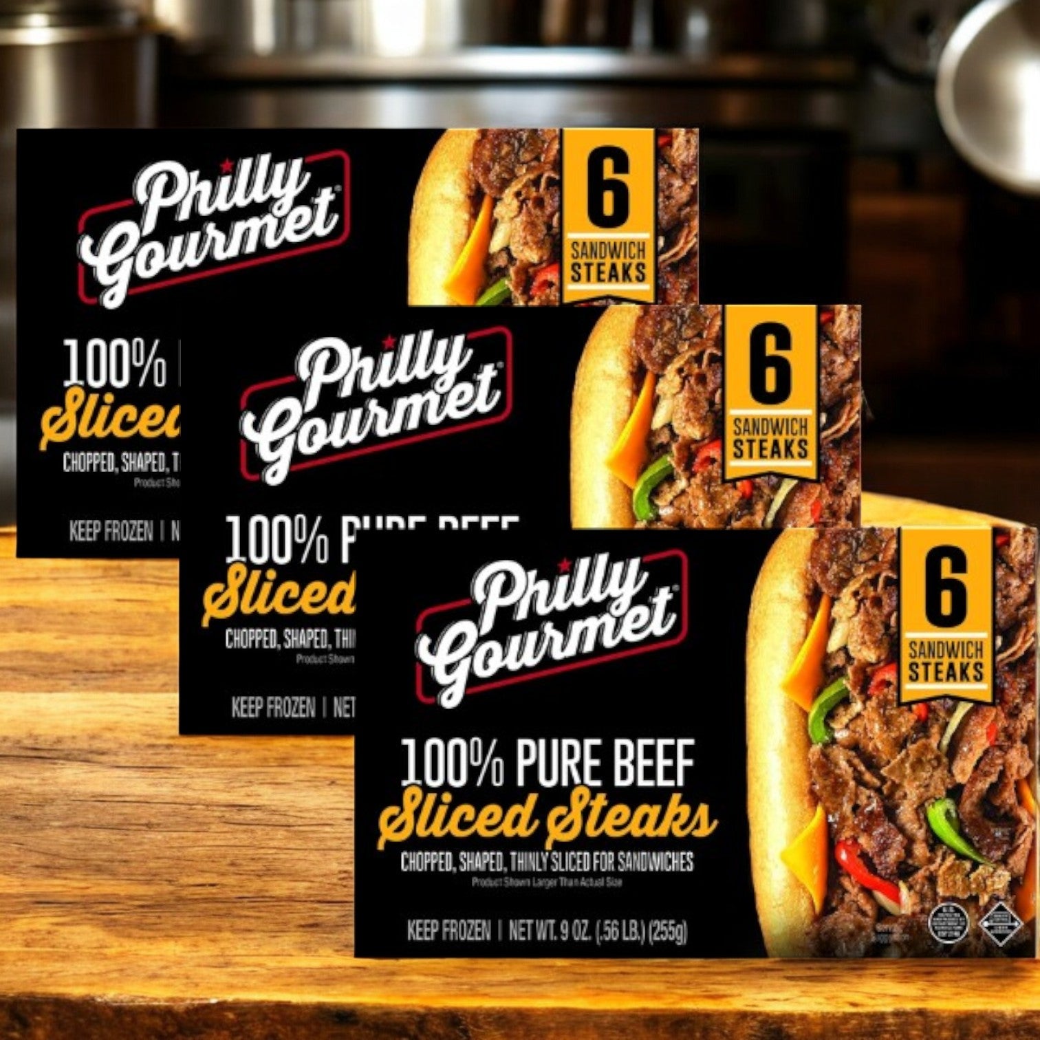 Three packs of Philly's Gourmet Philly Gourmet Steaks, 100% Pure Beef Sliced, are displayed on a kitchen counter, each pack containing six sandwich steaks.