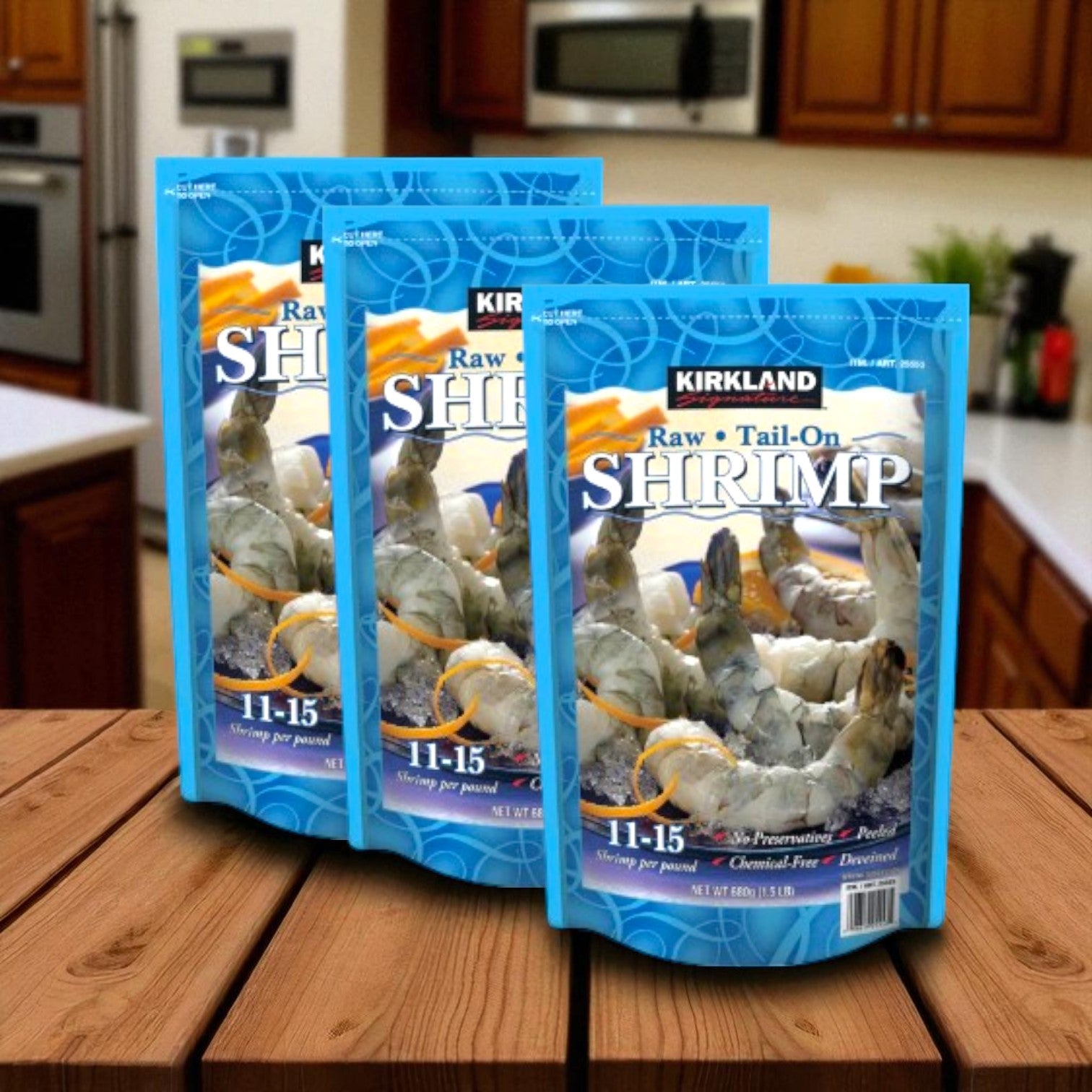 Three bags of Kirkland Signature Raw Shrimp (1.5 lbs each) from Kirkland Signature are displayed on a wooden surface, highlighting their premium quality and individually quick frozen freshness.