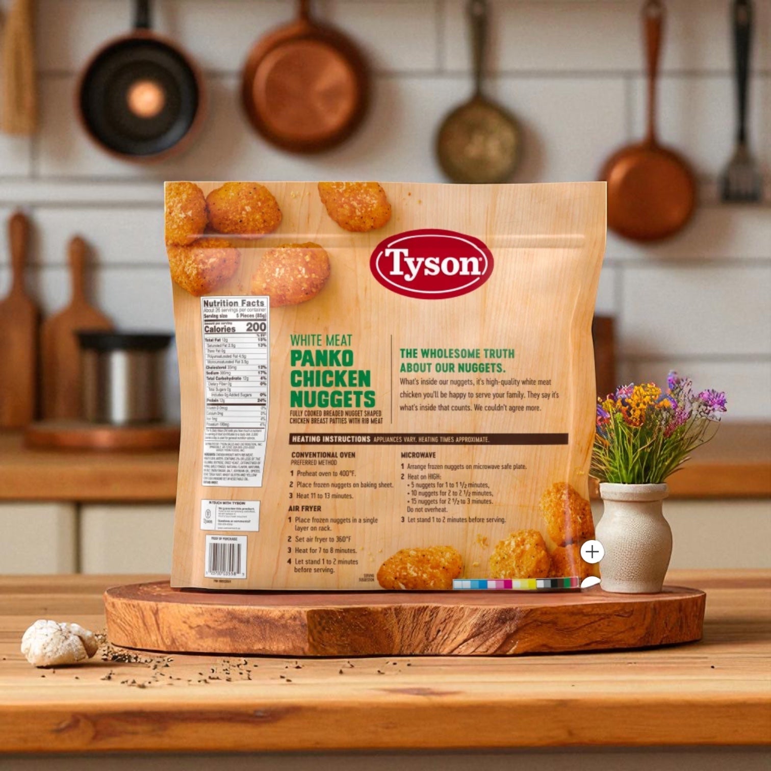 A 5-lb bag of Tyson Panko Chicken Nuggets rests on a wooden board in the kitchen next to a broccoli and cheese frozen entrée, with flowers and utensils visible in the background.