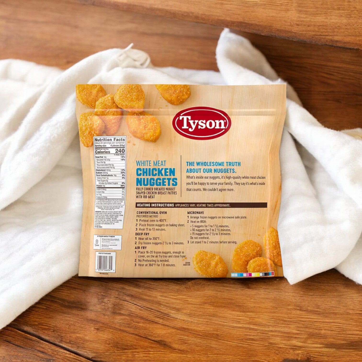 A bag of Tyson White Meat Chicken Nuggets, Frozen, 5 lbs is placed on a white cloth on wooden steps. The front label displays nutrition facts, preparation instructions, and product information from Tyson, highlighting its protein-packed content.