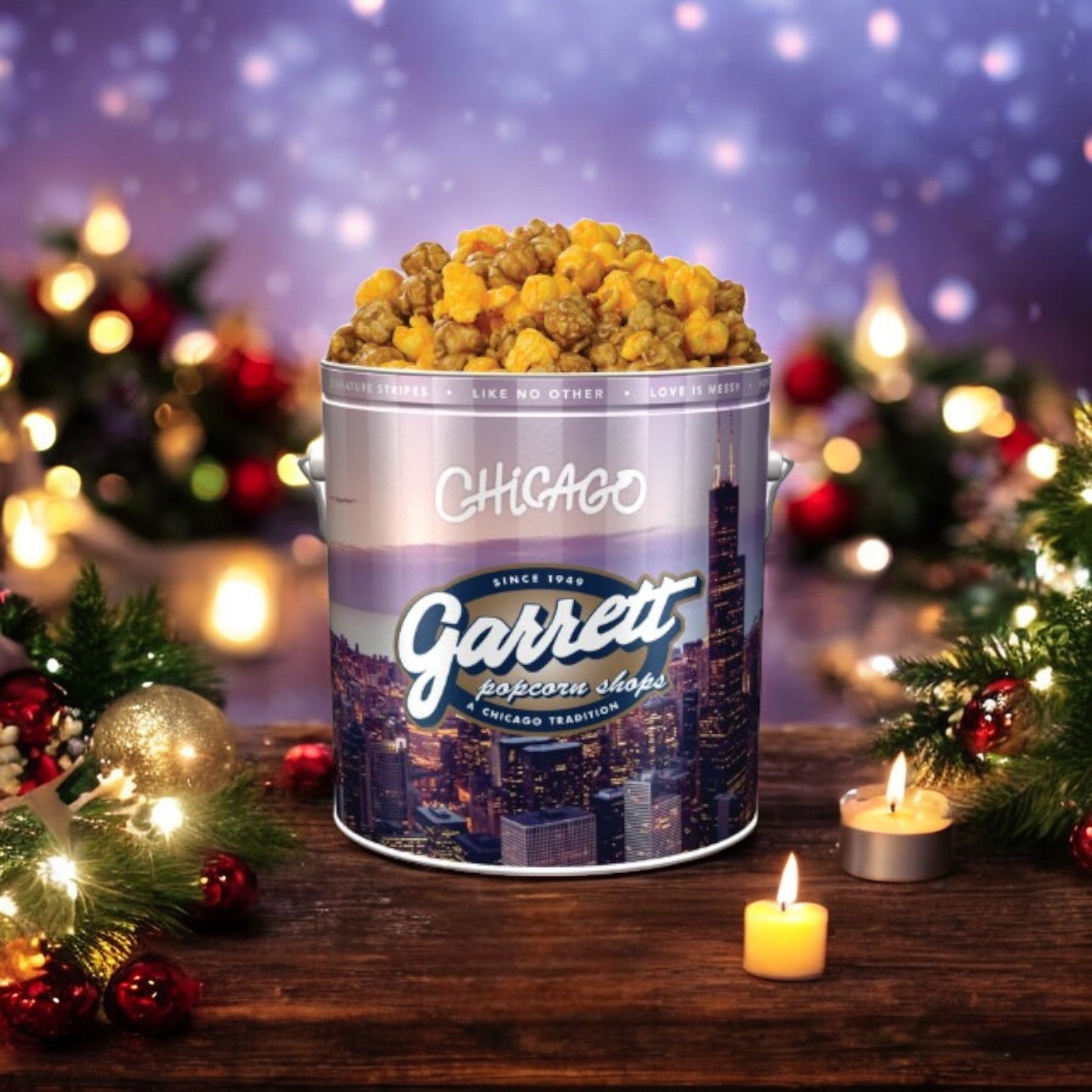 A festive tin from Easy Lunches’ Chicago's 2 Pack Combo! Free Shipping! features a delightful blend of caramel and cheese popcorn, elegantly displayed amidst holiday decorations and glowing candles on a wooden table.