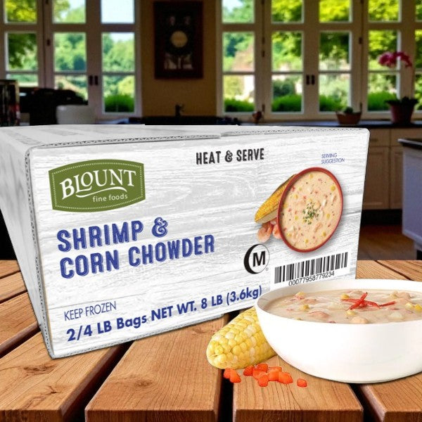 A box of Easy Lunches Blount Frozen Shrimp & Corn Chowder (2 packs, 4 lbs each) is on a kitchen counter beside a bowl of creamy chowder with corn and shrimp. Enjoy coastal-style, restaurant-quality flavor ready to heat and serve at home.