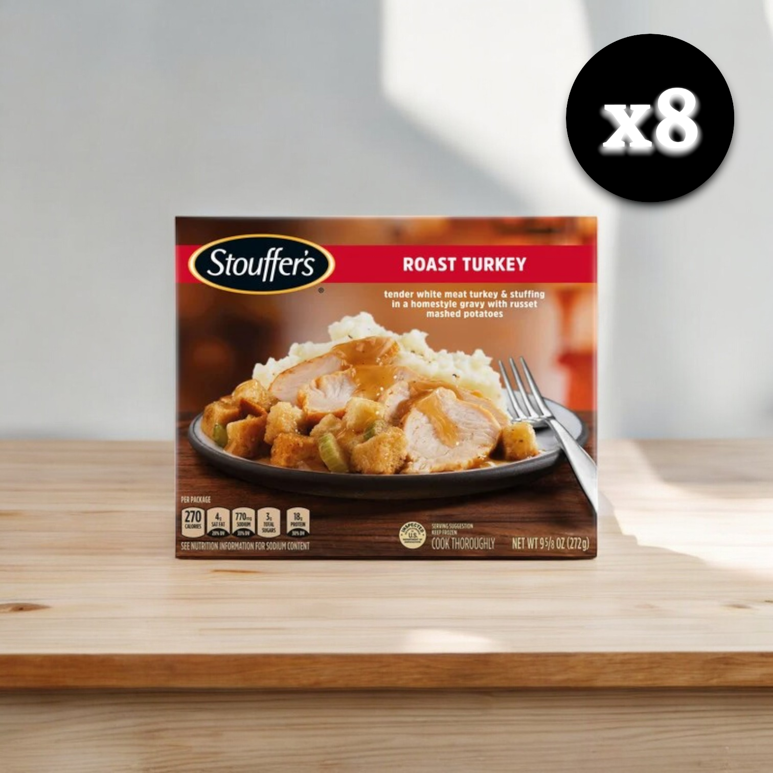 A cardboard box labeled "Stouffer's Roast Turkey, 9.625 oz. - 8 Count" with a picture of a Stouffer's Roast Turkey meal featuring homestyle gravy and creamy mashed potatoes beside it. The box is set on a dark marble surface.