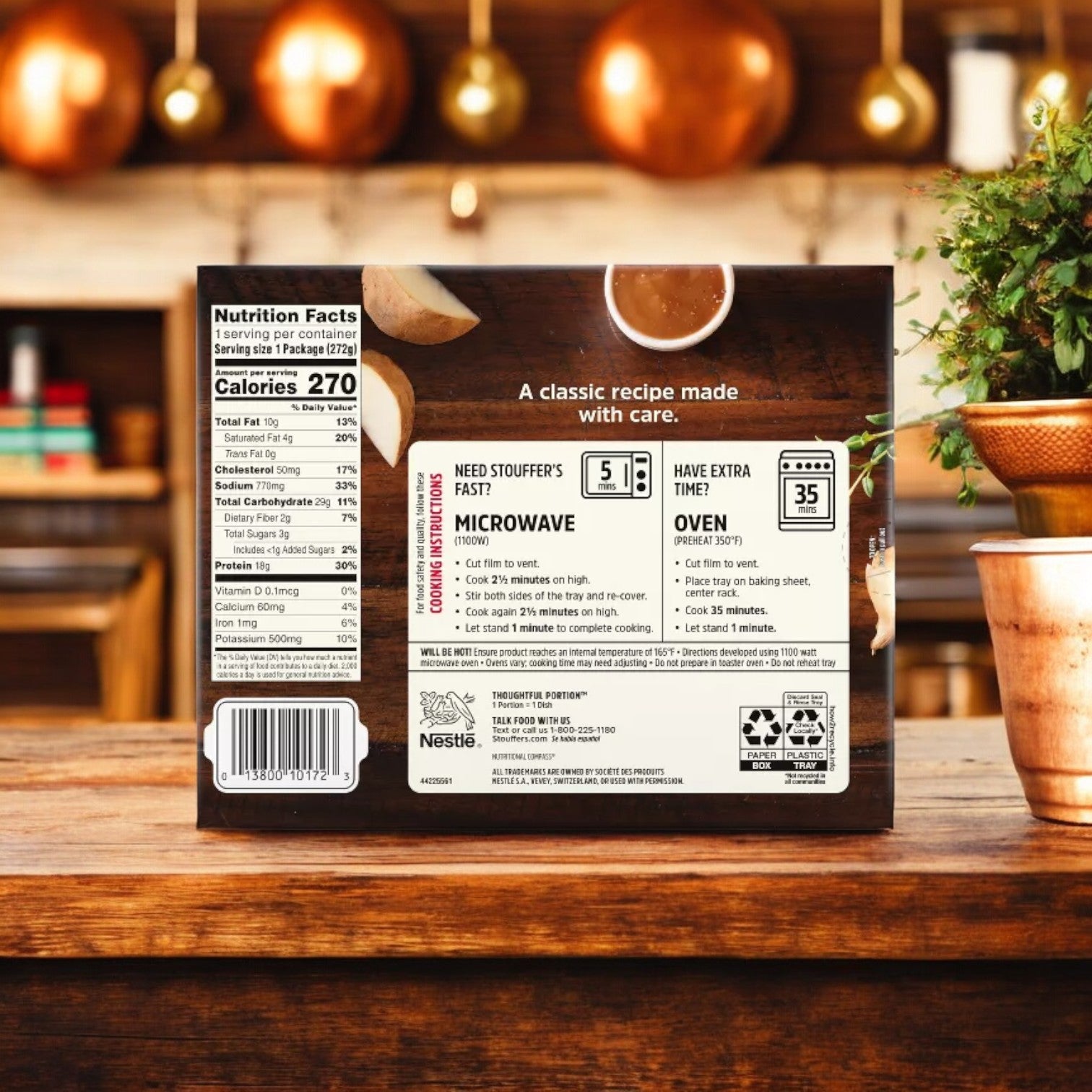 The back of a frozen food package for Stouffer's Roast Turkey, 9.625 oz. - 1 Count, displays nutrition facts, cooking instructions, and recycling information. Positioned on a wooden kitchen counter with pots and a plant in the background, it features homestyle gravy and creamy mashed potatoes.