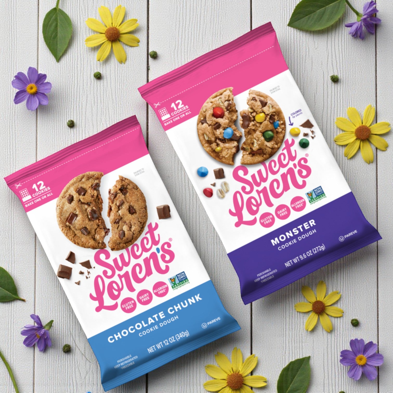 Two Sweet Loren's Cookie Dough packs—Monster (9.6 oz) and Chocolate Chunk (12 oz, gluten-free & vegan)—rest on a light wooden surface with colorful flowers, highlighting this delicious combo.