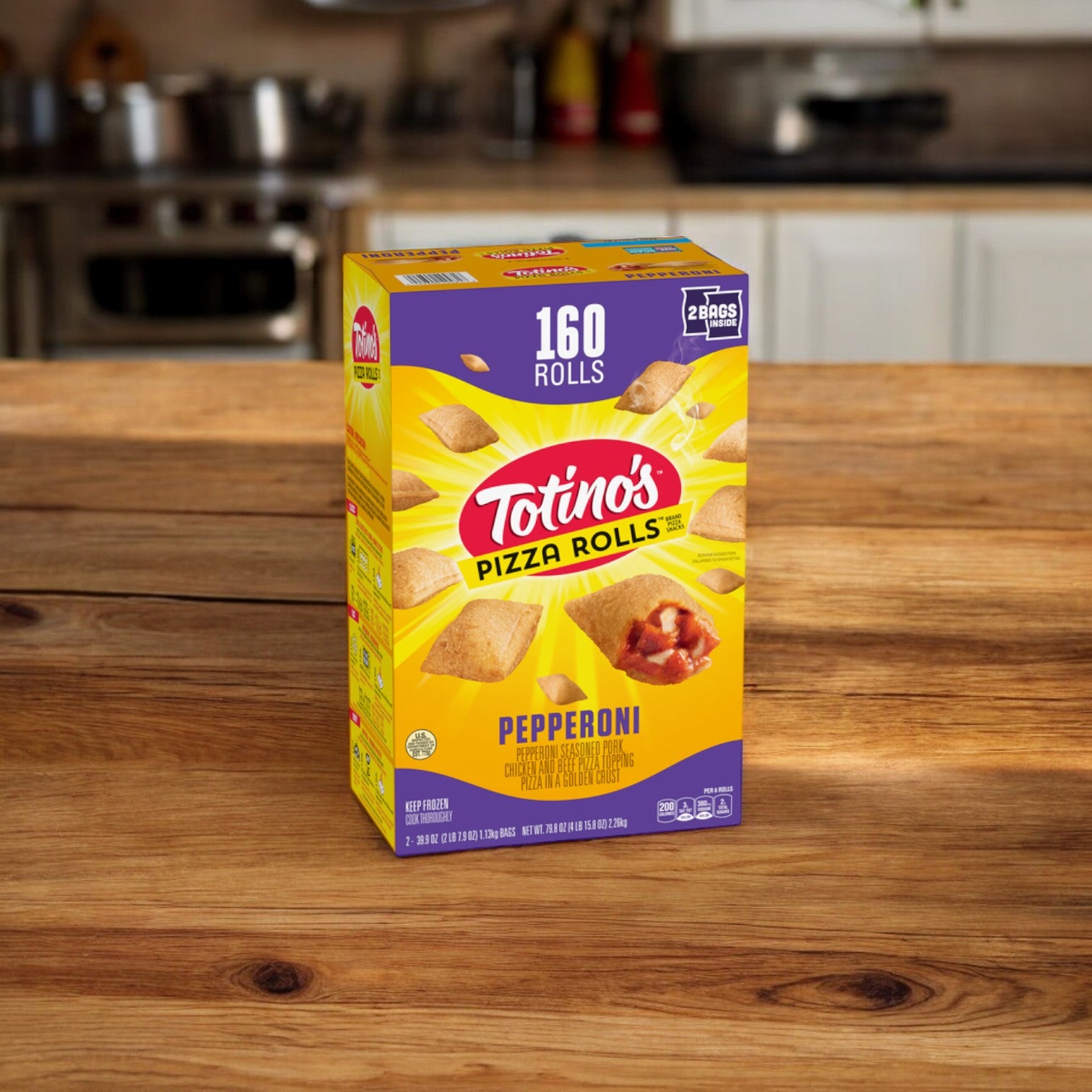 A box of Easy Lunches Totino's Pizza Rolls Pepperoni Flavored, containing 160 rolls and weighing 79.8 oz., sits on a wooden kitchen counter with kitchen appliances and white cabinets in the background. Crispy on the outside and gooey on the inside, these rolls are the perfect snack for any time.