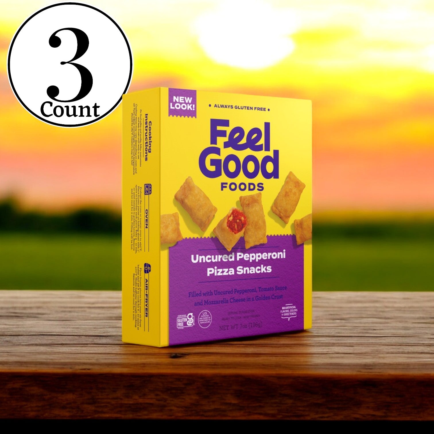 A package of Feel Good Foods Uncured Pepperoni Pizza Snacks, complete with a gluten-free crust, is placed on a wooden surface against the backdrop of a sunset. In the top left corner, there is a circular icon displaying "3 Total Boxes.