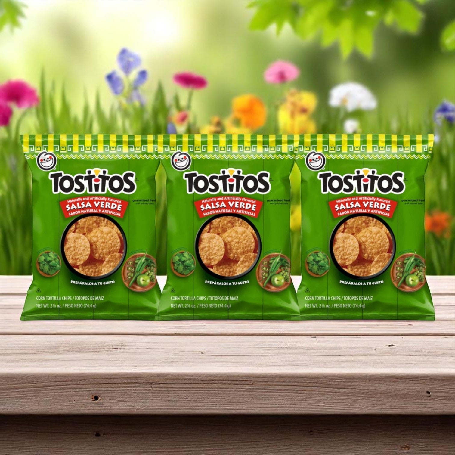 Three E.A. Sween 10-Pack Wrap & Sub Sandwich Bundles with 10 Assorted Snack Chips each are displayed on a wooden surface, set against a blurred outdoor background with flowers and greenery.