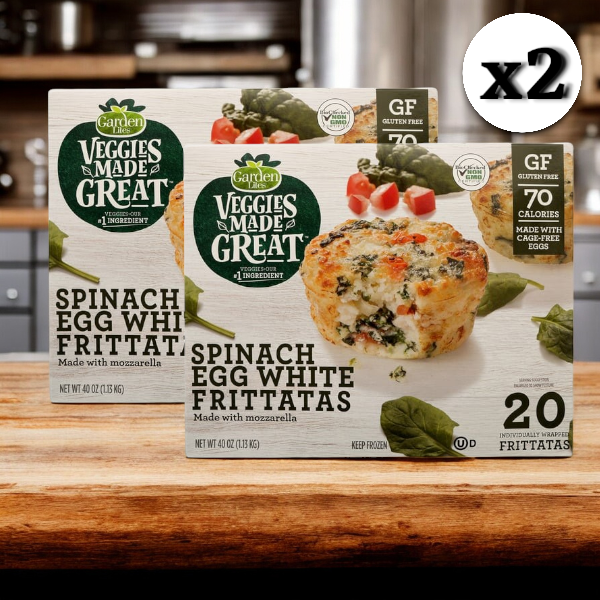 A pair of boxes of Veggies Made Great Garden Lites Vegetarian Spinach & Egg White Frittatas are displayed on a wooden surface, offering a tasty vegetarian spinach frittata choice. Each box contains 20 protein-rich frittatas, boasting their gluten-free nature and appealing as a low-calorie breakfast option with only 70 calories per serving.