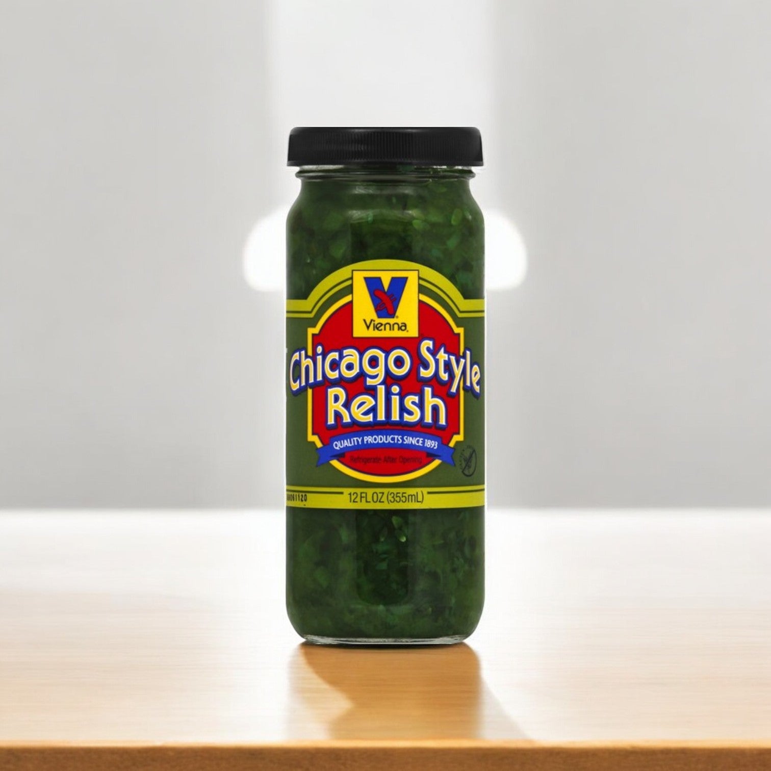 Jar of Vienna Beef's Chicago Style Relish, 12 oz., with a black lid on a wooden surface against a neutral background, offers an authentic sweet and tangy Chicago flavor.