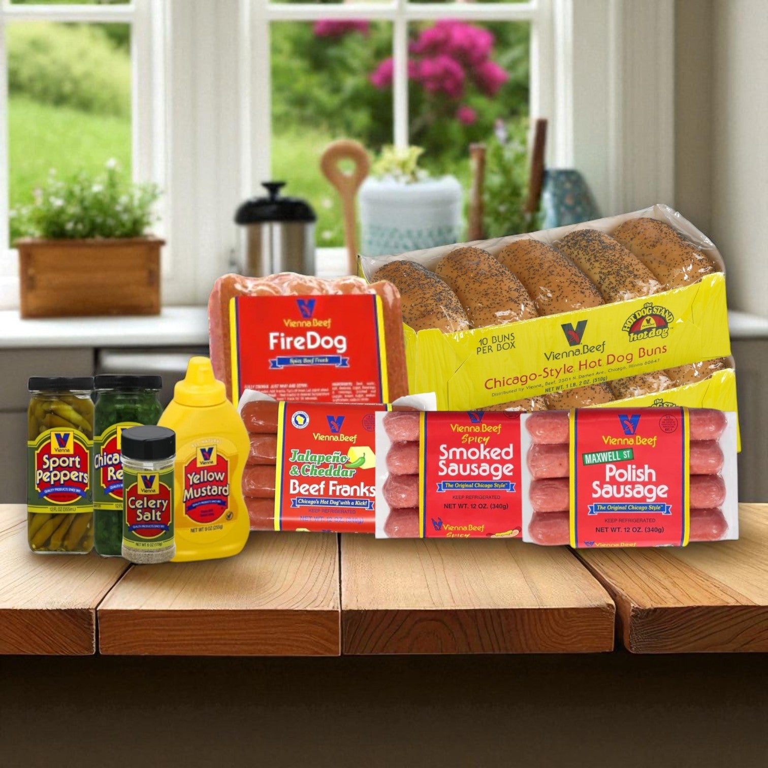 A Chicago-Style Vienna Beef Hot Dog Complete Kit by Vienna Beef, with hot dogs, Polish sausages, buns, and classic toppings, is arranged on a kitchen counter with a window in the background.