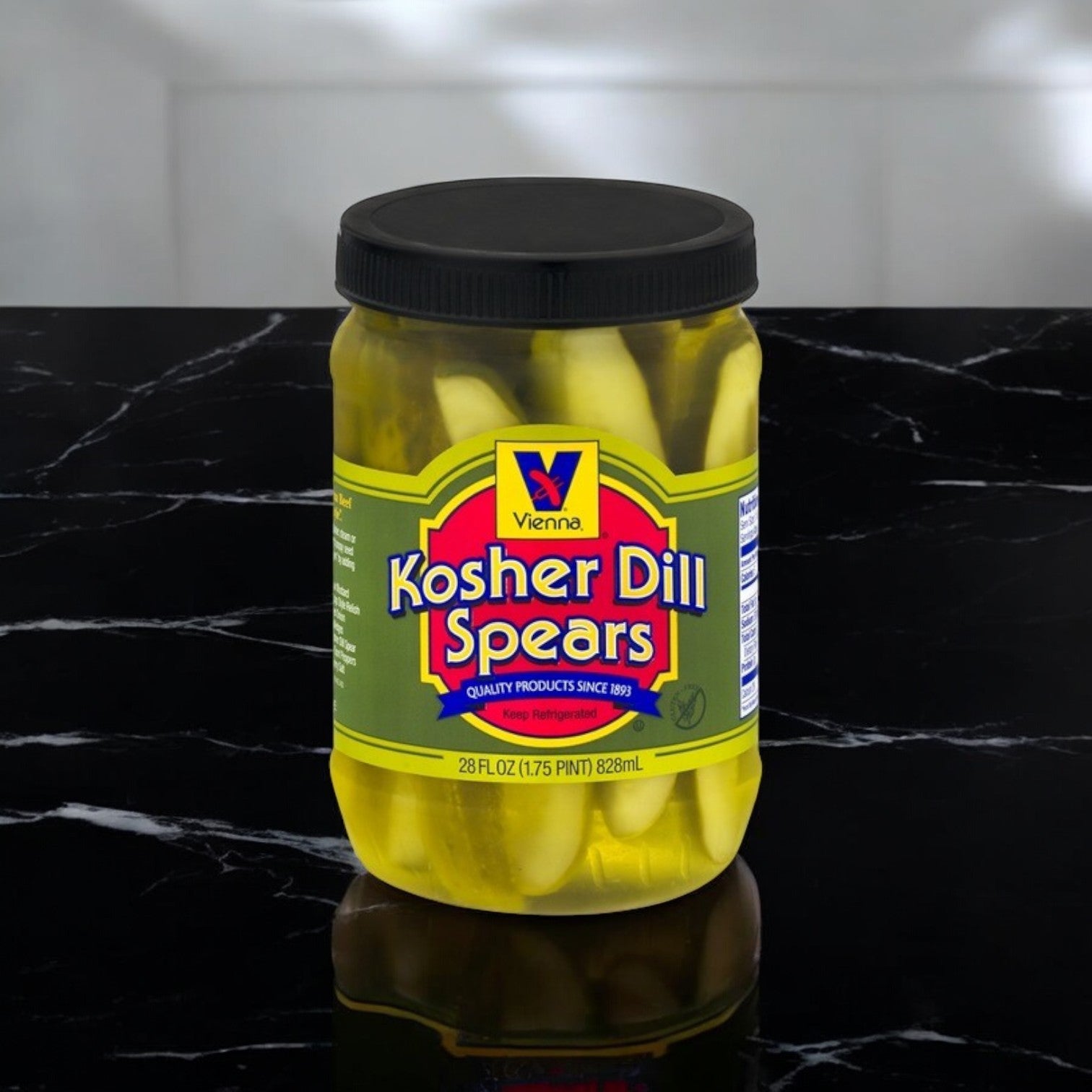 A jar of Vienna Beef's Kosher Dill Spears rests on a black marble surface, featuring a zesty flavor and a crisp, crunchy texture. The label indicates it contains 28 oz. (1.75 pt) 828 ml, promising a delightful experience with every bite.