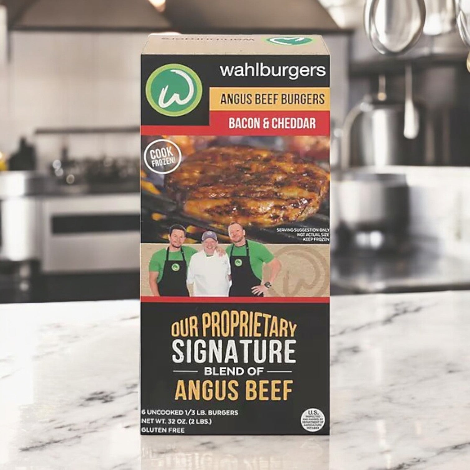 A 32 oz box of Wahlburgers Frozen Beef Patties, Bacon & Cheddar, rests on the kitchen counter, highlighting the Angus beef's rich flavor. The packaging features an enticing burger image and iconic branding.