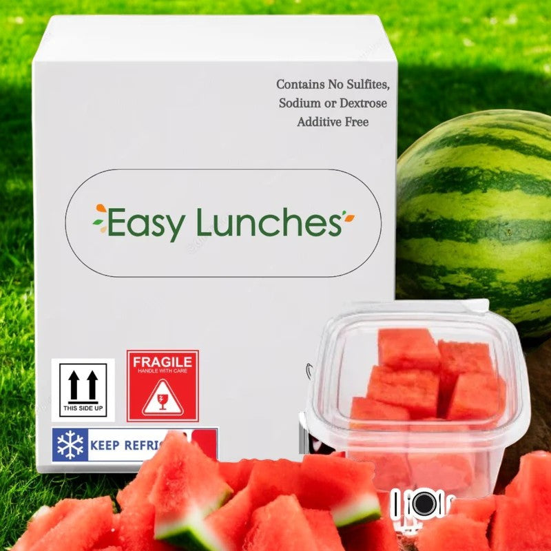 A box labeled "Easy Lunches" features "Watermelon Chunks Fresh, 2.5 oz. - 100 Count- Made to Order!" with images of watermelon slices, red seedless grapes in a plastic container, and a whole watermelon in the background. Labels highlight nutrient-rich, additive-free contents and provide handling instructions for guaranteed freshness.