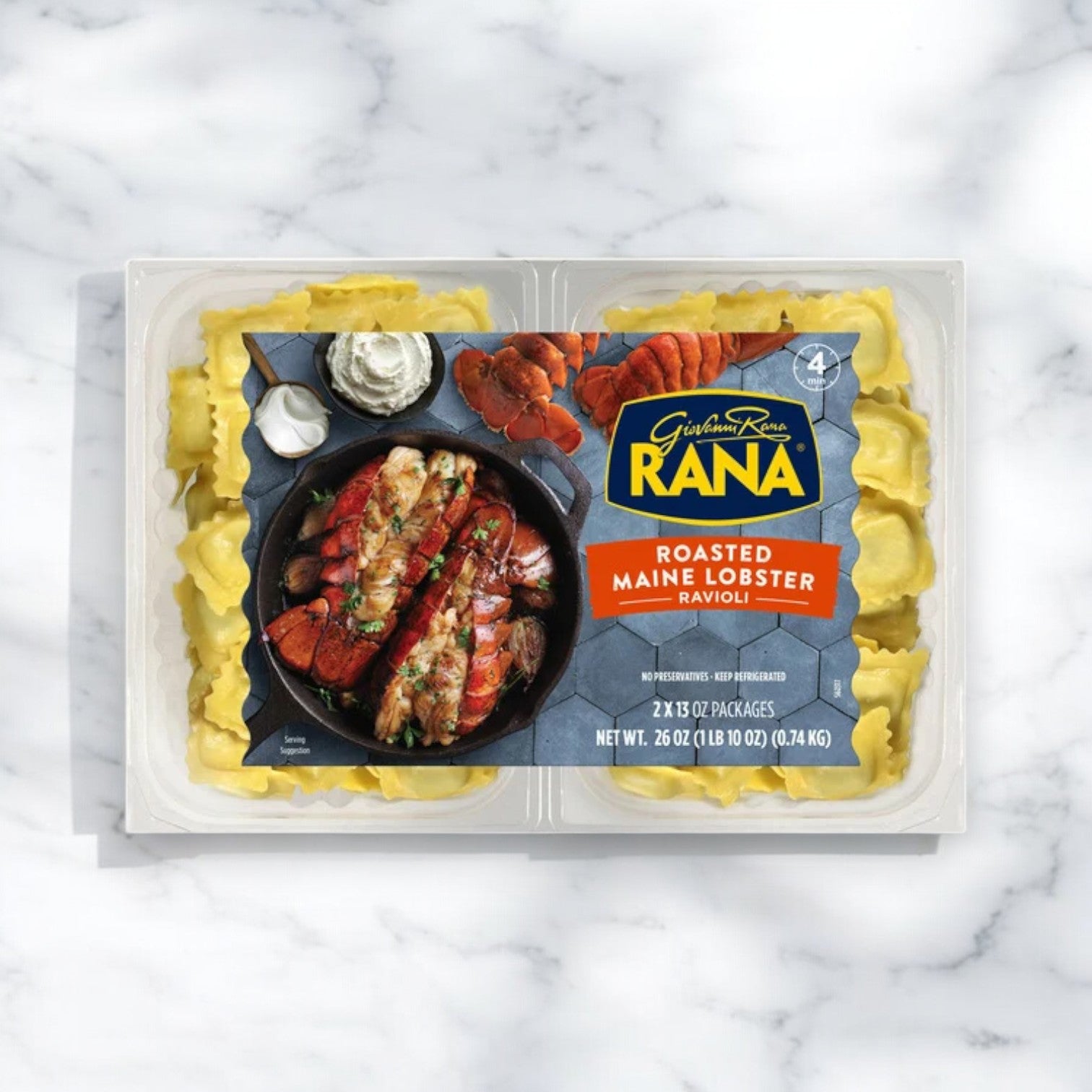 On a marble surface, the Giovanni Rana Maine Lobster Ravioli (26 oz, 2-pack) packaging is displayed, featuring authentic Italian pasta with an image of lobster elegantly arranged on a black plate.