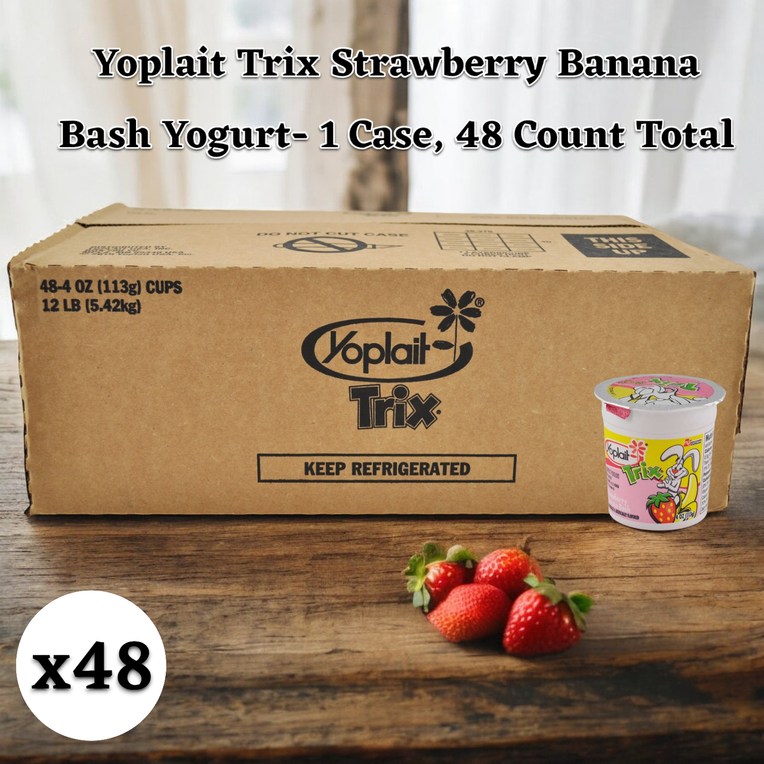 A cardboard case of Yoplait Trix Strawberry Banana Bash Yogurt, a kid-approved snack with no high fructose corn syrup, contains 48 cups. They're arranged on a wooden surface, with three strawberries near a single yogurt cup in the foreground.