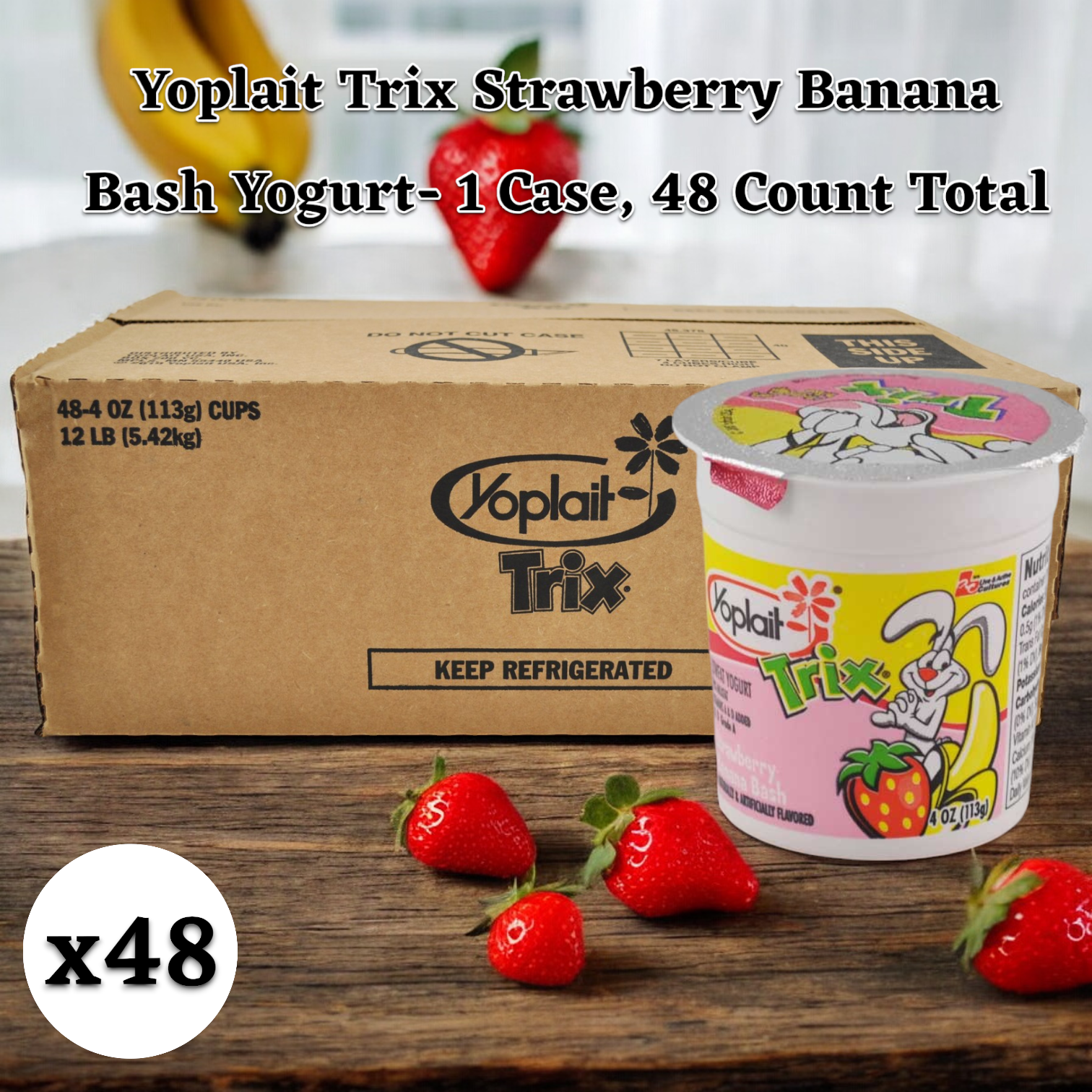 A kid-approved snack, this case of Yoplait Trix Strawberry Banana Bash Yogurt, containing 48 individual 4 oz. cups, sits next to a yogurt cup and fresh strawberries on a wooden surface. Free from high fructose corn syrup, it's the perfect treat for your little ones.