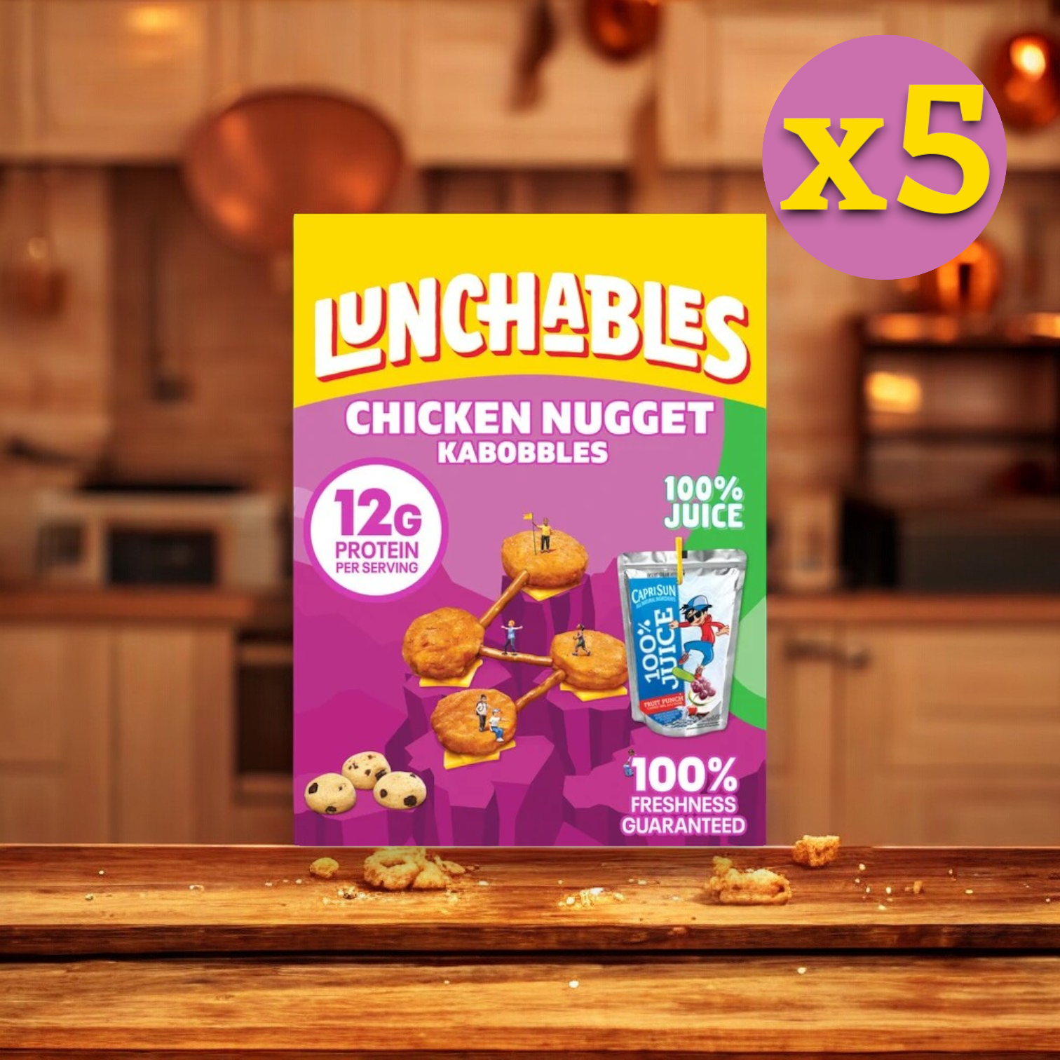 A 9 oz. box of Lunchables Chicken Nugget Kabobbles, featuring 12g of protein per serving and 100% juice, sits on a kitchen counter. With a "5 Pack" label indicating a quantity of five, this convenient meal from Lunchables is perfect as an on-the-go snack.