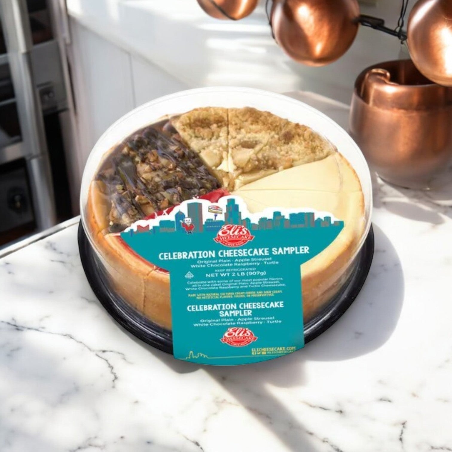 An Eli's Cheesecake Variety Pack! 2 Pizza's And A Cheesecake Sampler! sits on a marble countertop, featuring four delectable slices next to copper mugs—ideal for topping off your Chicago-style feast.