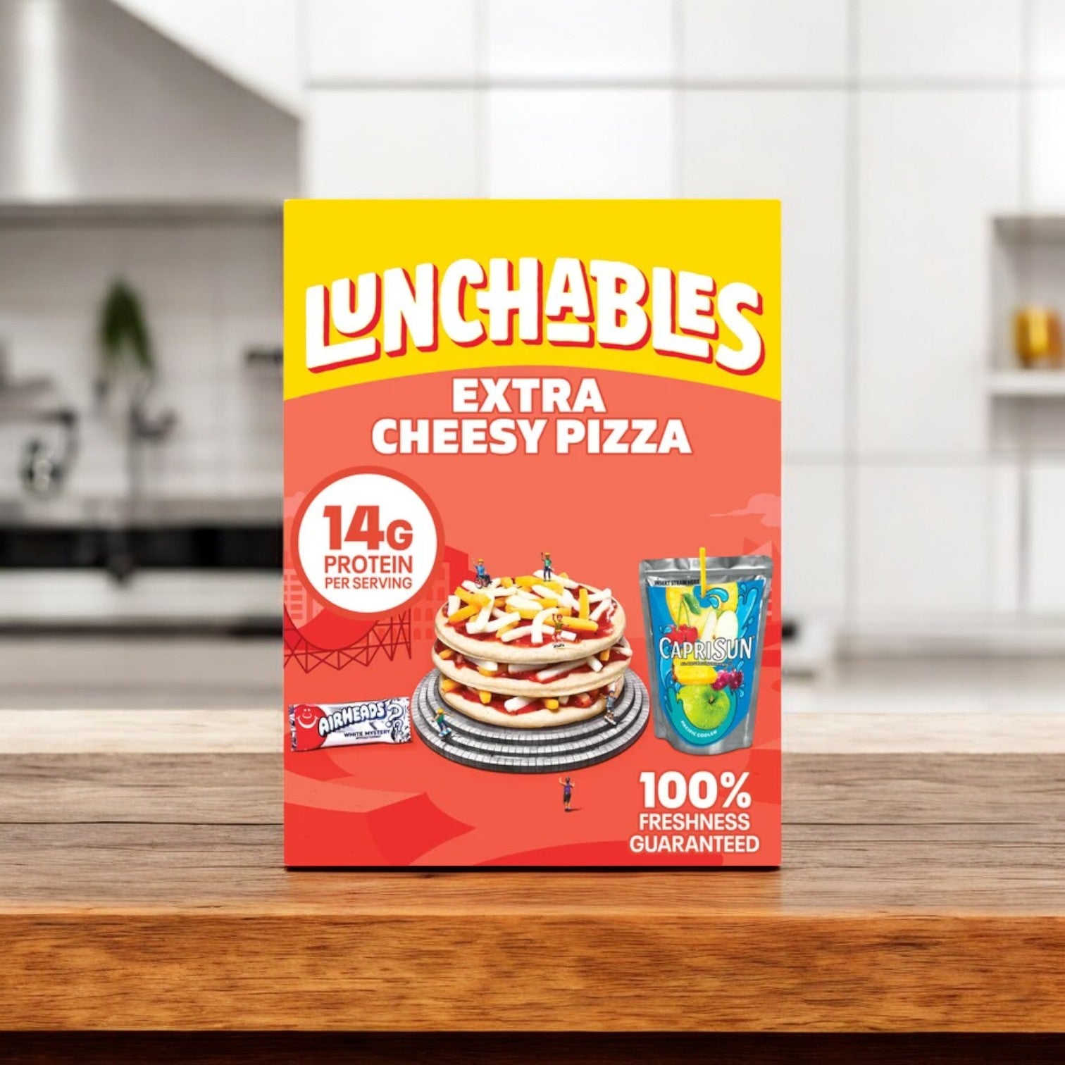 A favorite from the Lunchables Variety Bundle, the Extra Cheesy Pizza sits on the kitchen counter. Highlighting 14g of protein per serving and boasting 100% freshness guaranteed, it offers one of the best quick meal solutions for your busy day.