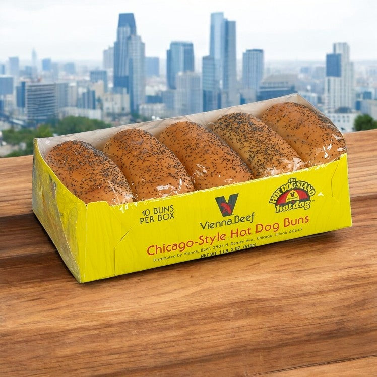 A 10-pack of Vienna Beef Poppy Seed Hot Dog Buns sits on a wooden table, labeled “Chicago-Style Hot Dog Buns,” with a city skyline in the background. Each case contains 12 packs (120 buns total).