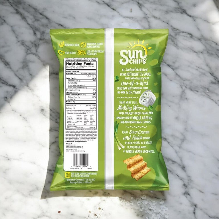 A bag of Sun Chips French Onion placed on a marble surface. This savory snack features sour cream and onion flavor, boasts whole grains, with nutritional facts and promotional text visible on the back of the bag.