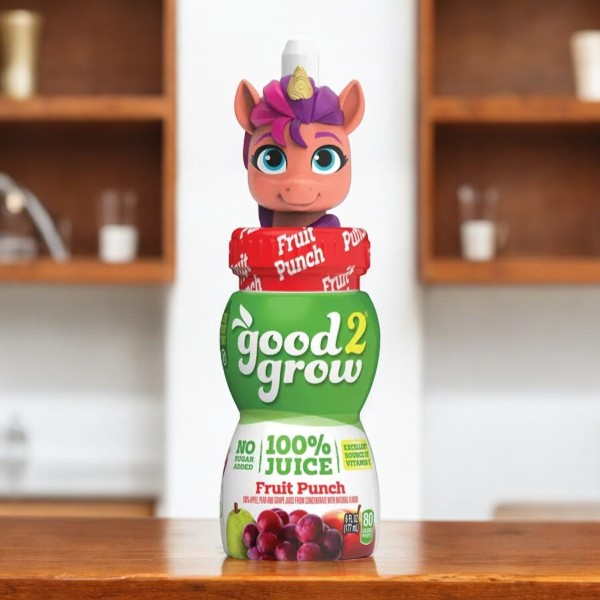 A 6-fluid ounce bottle of Good2grow Single Serve Fruit Fusion from Easy Lunches, featuring a colorful unicorn character top, placed on a wooden surface with a blurred kitchen background—a healthy kids' drink that makes single-serve fruit juices fun and appealing.