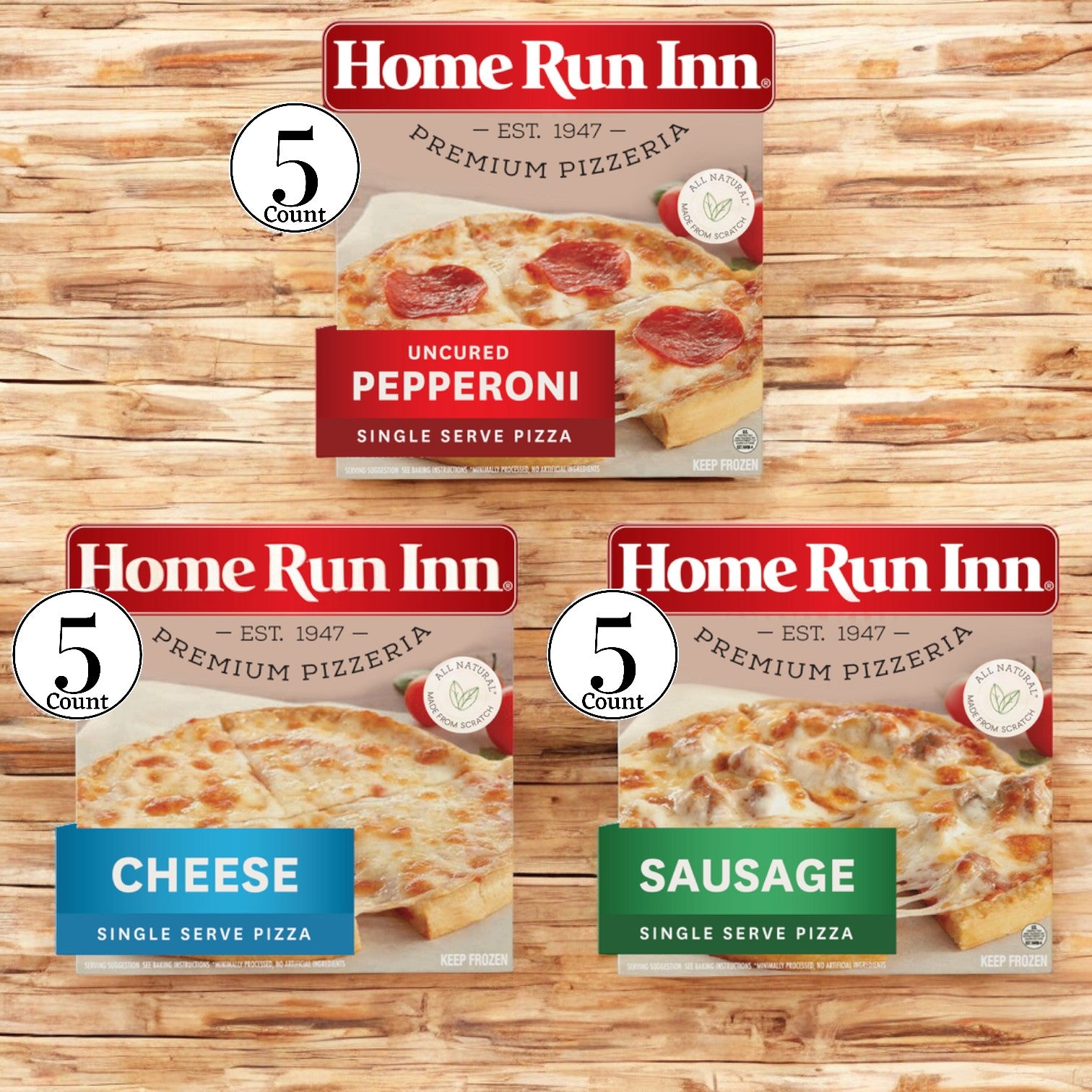 On a wooden surface, three boxes of Home Run Inn Mini Personal Serving Sized Variety Packs are displayed, featuring flavors like uncured pepperoni, cheese, and sausage. Each box contains five-count packages of pizzas with a buttery flaky crust topped with rich mozzarella cheese.