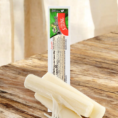 A partially peeled Frigo Cheese Heads Original Mozzarella String Cheese labeled "TreeToppers SPRING" sits on a wooden surface. The low-moisture part-skim mozzarella cheese stick lies beside its packaging, which displays product information. This high-protein snack offers a delicious and convenient choice.