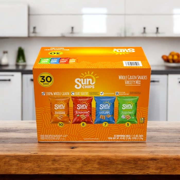 A cozy kitchen showcases a SunChips Variety Pack Whole Grain Chips, featuring 30 packs of Harvest Cheddar, Garden Salsa, Original, and French Onion flavors. Enjoy the wholesome goodness with no artificial flavors from Sun Chips.