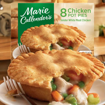 Image of a box of Marie Callender's Chicken Pot Pies, Frozen- 1 Pack (8 Pot Pies), showcasing a close-up of a baked pot pie filled with chicken, peas, carrots, and gravy on a plate in the foreground. Enjoy this nutritious meal from Marie Callender's with convenient preparation for your busy days.