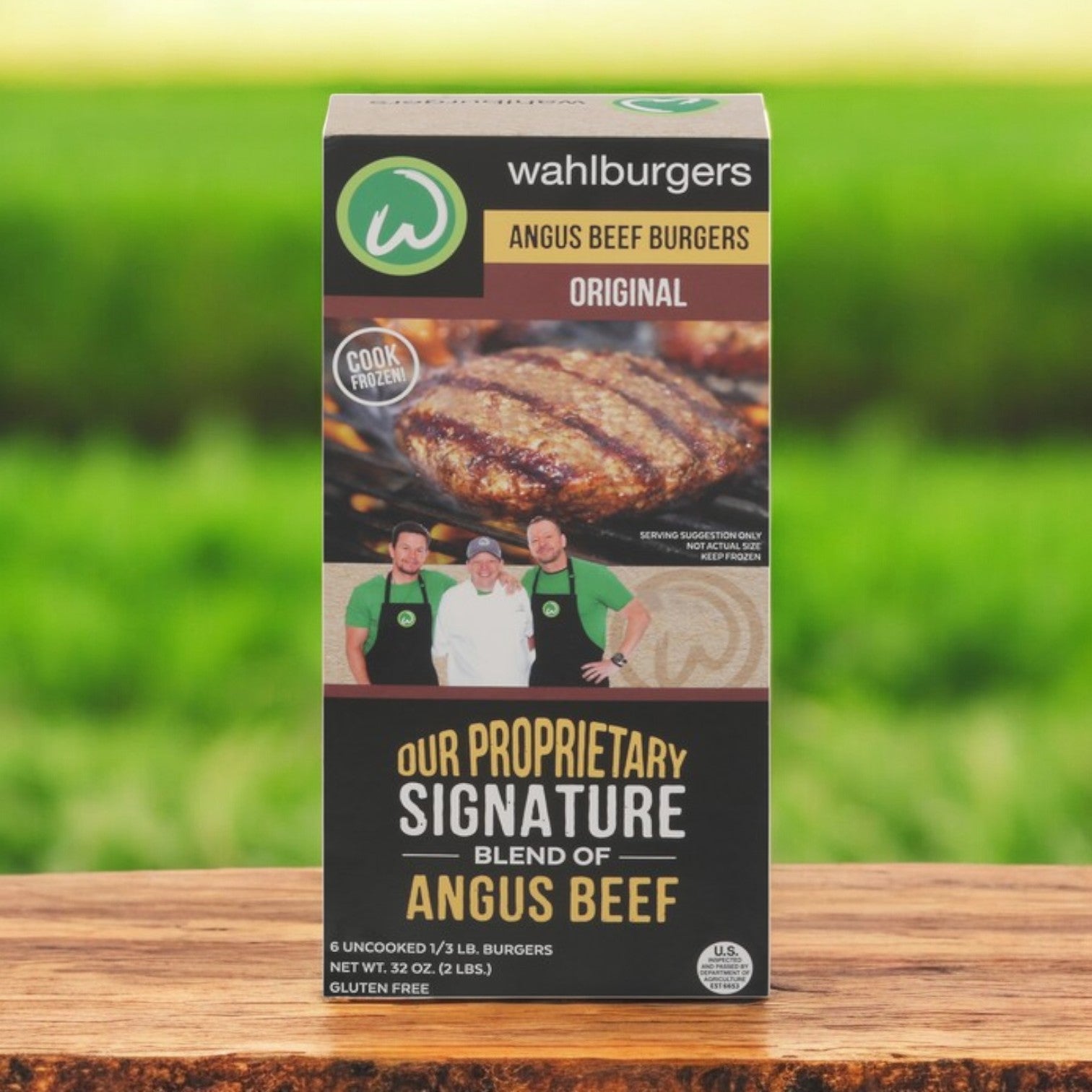 Wahlburgers Angus Beef Burgers, Original flavor, come in a 6 ct, 32 oz pack (3 boxes total) with gluten-free restaurant-quality taste. The packaging highlights a mouthwatering cooked burger image and features three people on the front. Perfect premium quality burgers for any occasion!.