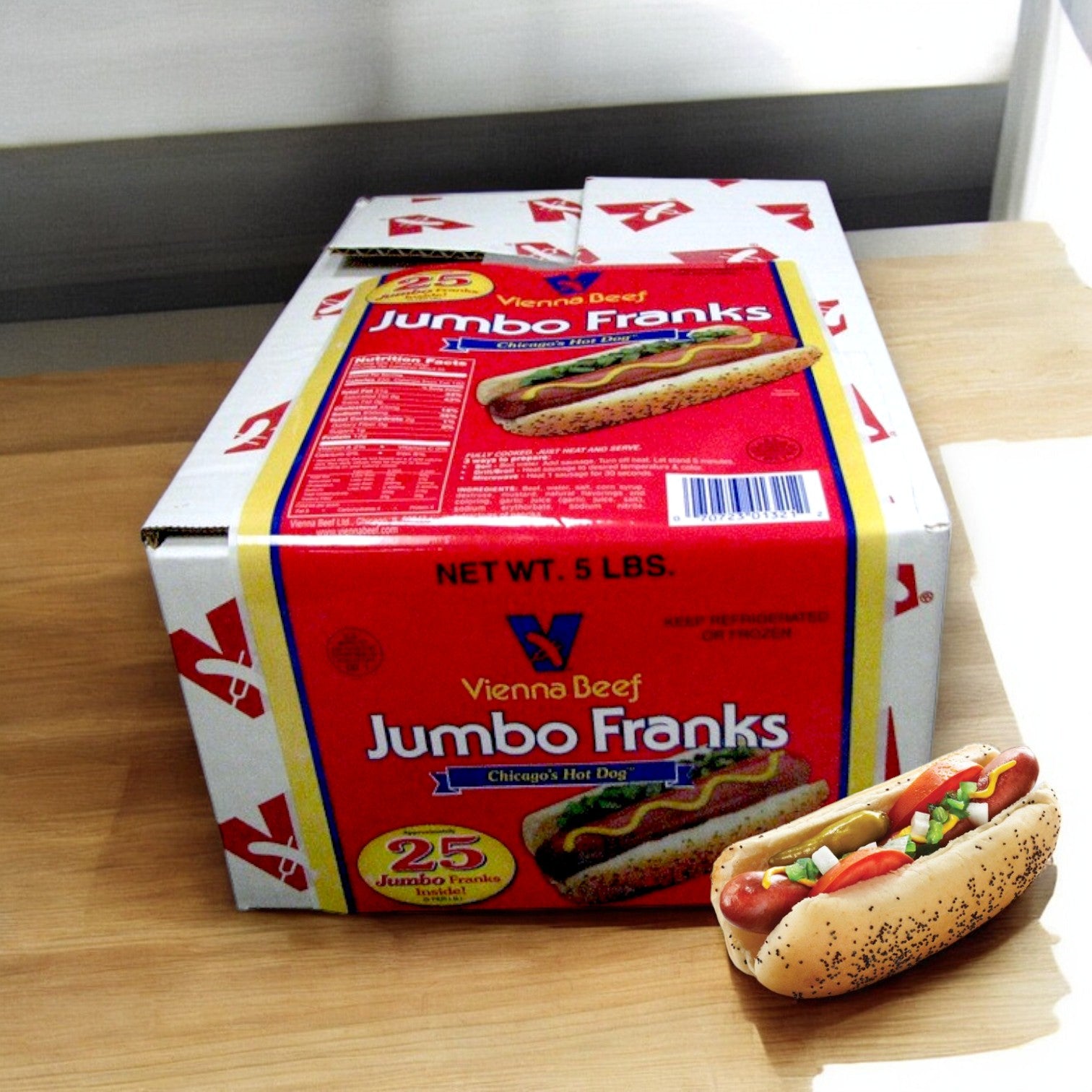 A box of "Vienna Beef Franks – 25 Count" by Vienna Beef rests on a table, featuring a Chicago-Style Hot Dog image. Beside it, a hot dog adorned with condiments represents premium beef quality.