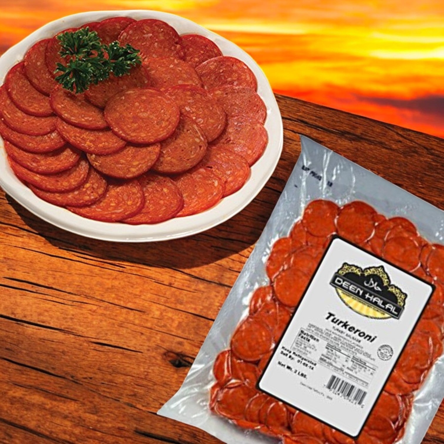 A plate of sliced Deen Halal Turkeroni, made from premium turkey, garnished with parsley sits next to a 2 lb. pack labeled "Deen Halal Turkeroni" on a wooden table, set against a stunning sunset backdrop.