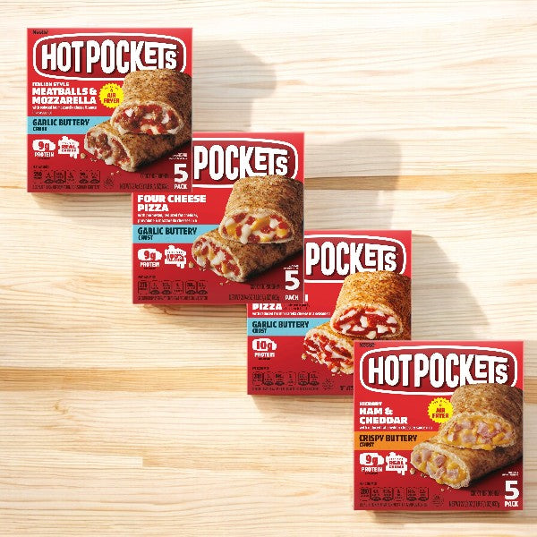 Four boxes of Easy Lunches Hot Pockets Variety Pack displayed on a wooden surface, each showcasing different flavors: Meatballs & Mozzarella, Four Cheese Pizza, Pepperoni Pizza, and Ham & Cheddar. Perfect for quick meals, this variety pack includes a total of 20 Hot Pockets and ensures there's something delicious for everyone to enjoy.