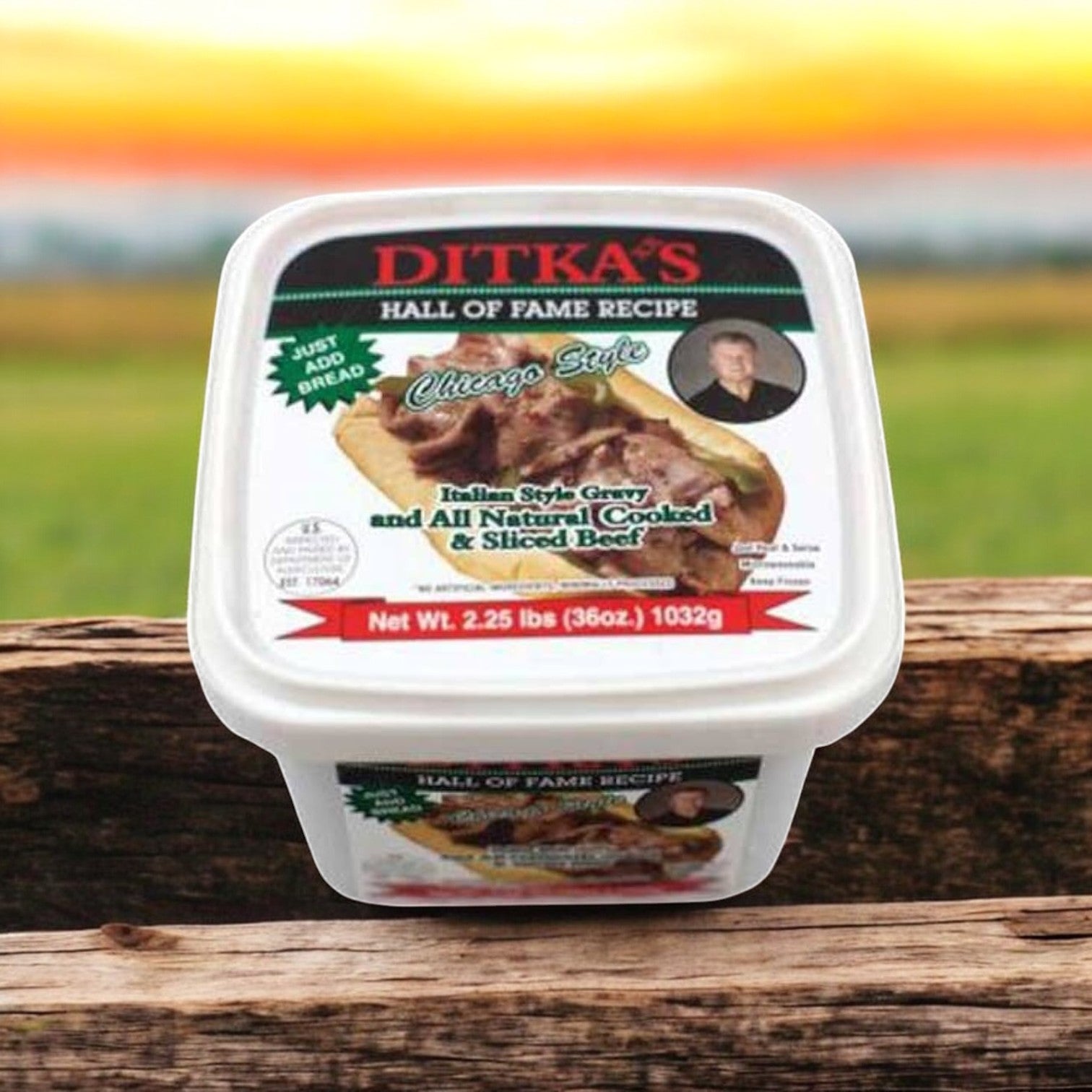 A container of Vienna Beef's Ditka's Italian Beef, Chicago Style (2.25 lb.), sits on a wooden surface with a blurred outdoor background, encapsulating the essence of Chicago style Italian beef.