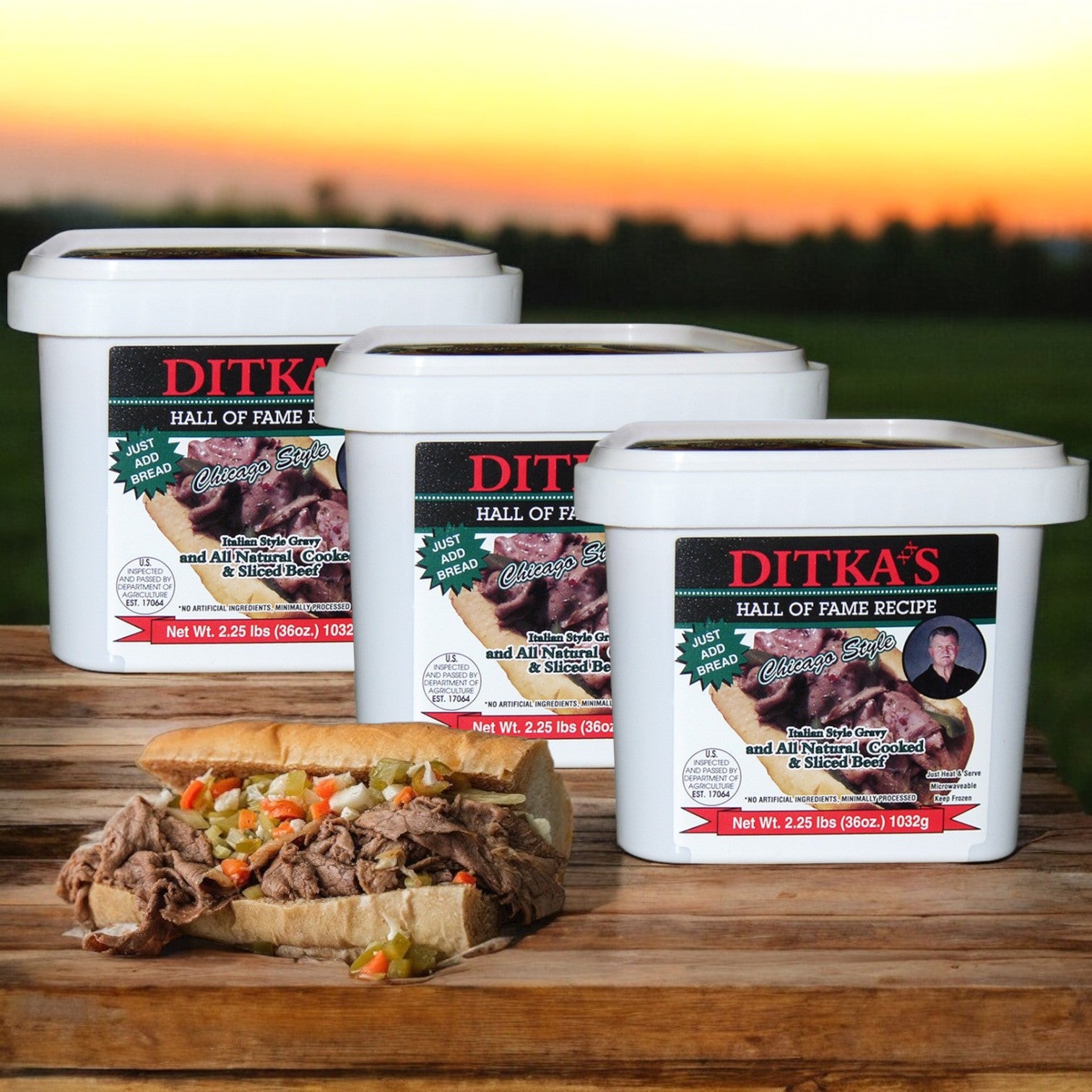 Three tubs of Ditka's Italian Beef, Chicago Style from Vienna Beef flank a Chicago-style sandwich set outdoors against a blurred backdrop.