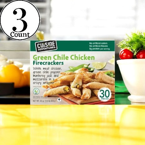 On display is a box of Cuisine Adventures Green Chile Chicken Firecrackers - 3 Count from Cuisine Adventure, highlighting a bold and flavorful snack featuring tender chicken wrapped in a crispy golden shell.