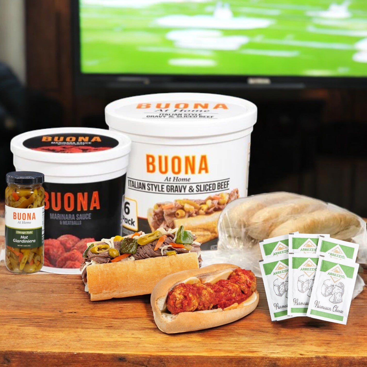 A variety of Buona-brand food items are showcased on a table, featuring the Buona Marinara Sauce & Meatballs Kit and Italian Beef for making a total of 12 sandwiches.