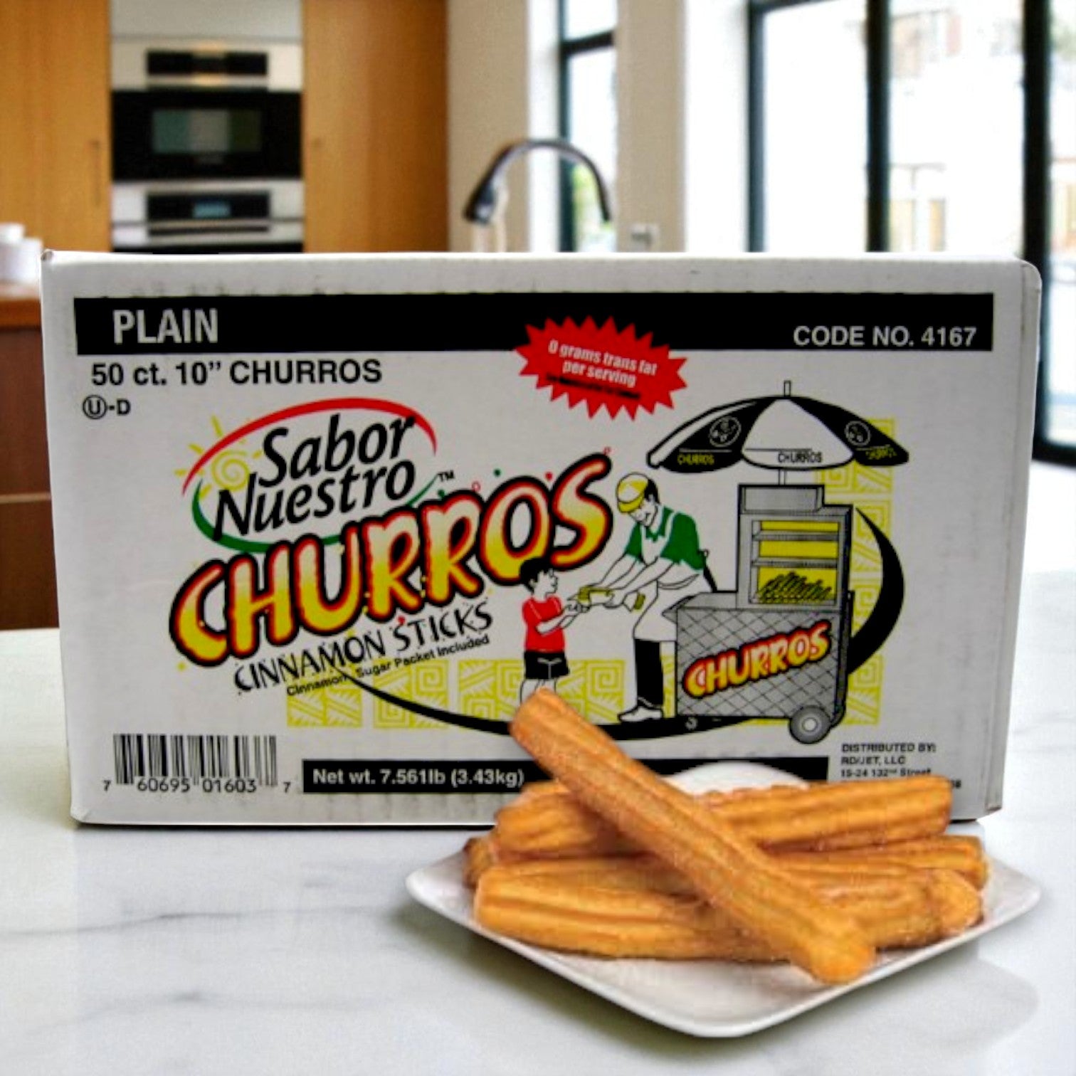 A box of Sabor Nuestro Frozen Cinnamon & Sugar Churros – 10" (2 oz each, 50 ct) sits on a counter behind a plate of churros in a modern kitchen.