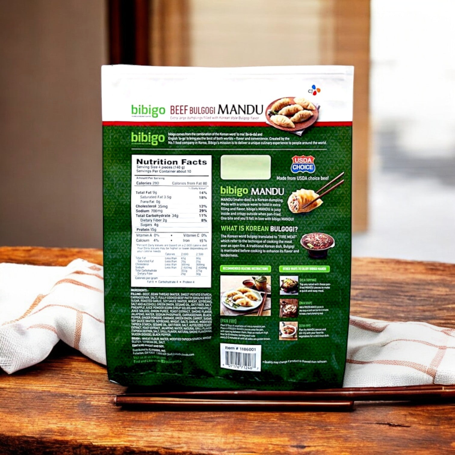 A 3-pound package of CJ Bibigo Beef Bulgogi Mandu Dumplings on a table displays Korean-style dumplings, nutritional facts, cooking instructions, and enticing images.