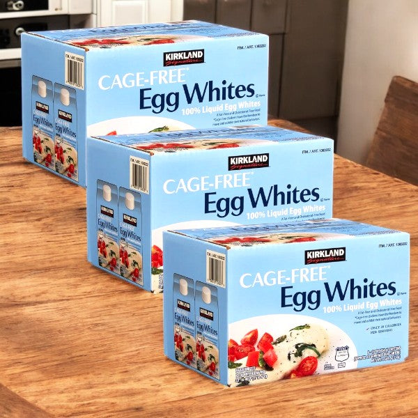 Three cases of Kirkland Signature Liquid Egg Whites, Cage Free, are on a wooden table. Each carton is marked as 100% liquid egg whites, guaranteeing quality and nutrition in every pour.