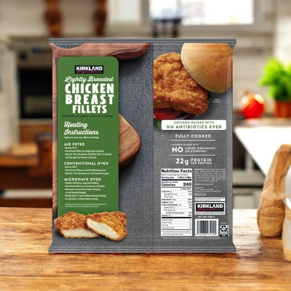 A Kirkland Signature box of 3 lightly breaded chicken breast fillets (3 lbs) is on the counter, ideal for meal prep. High in protein, it provides all product details and cooking instructions for a nutritious, convenient choice.