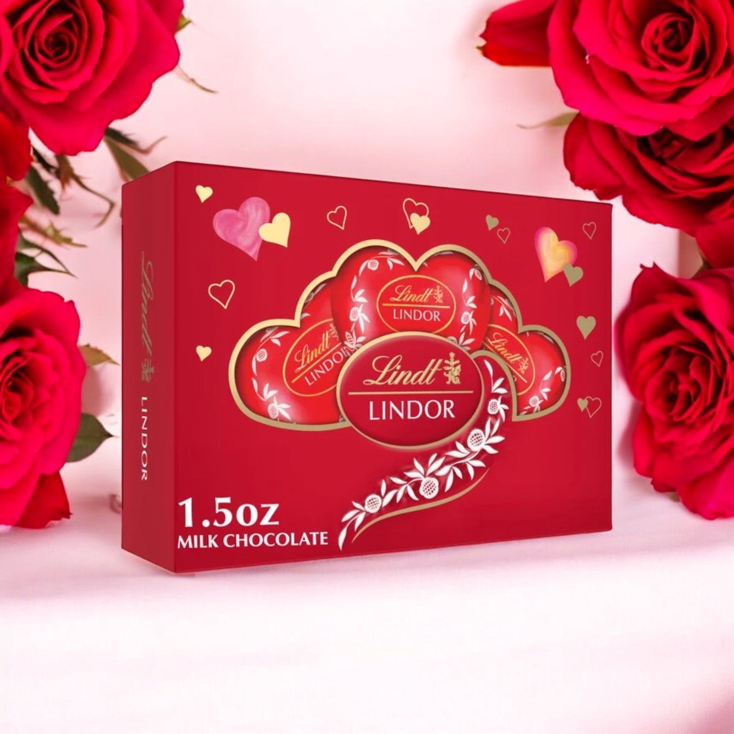 Surrounded by red roses, the Lindt Lindor Valentine's Milk Chocolate Candy Truffles 1.5 oz Heart Gift Box makes a perfect gift for your loved one.